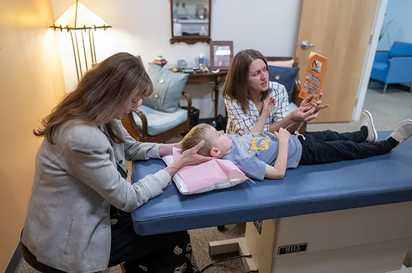 Physician examining a young patient in the Georgia Osteopathic Care Center